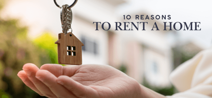 Hand holding a small wooden house keychain over an open palm, representing renting a home — feature image for ‘10 Reasons to Rent a Home’ in Midland, MI.