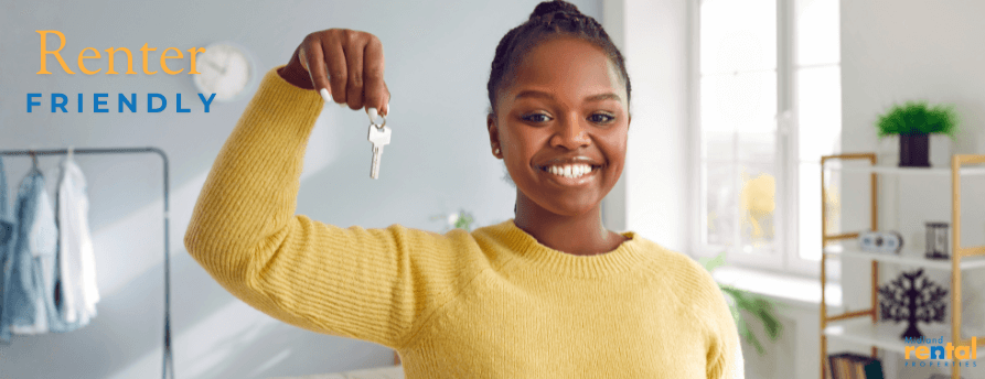 Smiling renter holding keys in a renter-friendly Midland, MI rental home